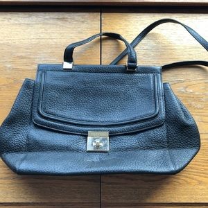 Black Kate Spade crossbody bag with gold clasp.